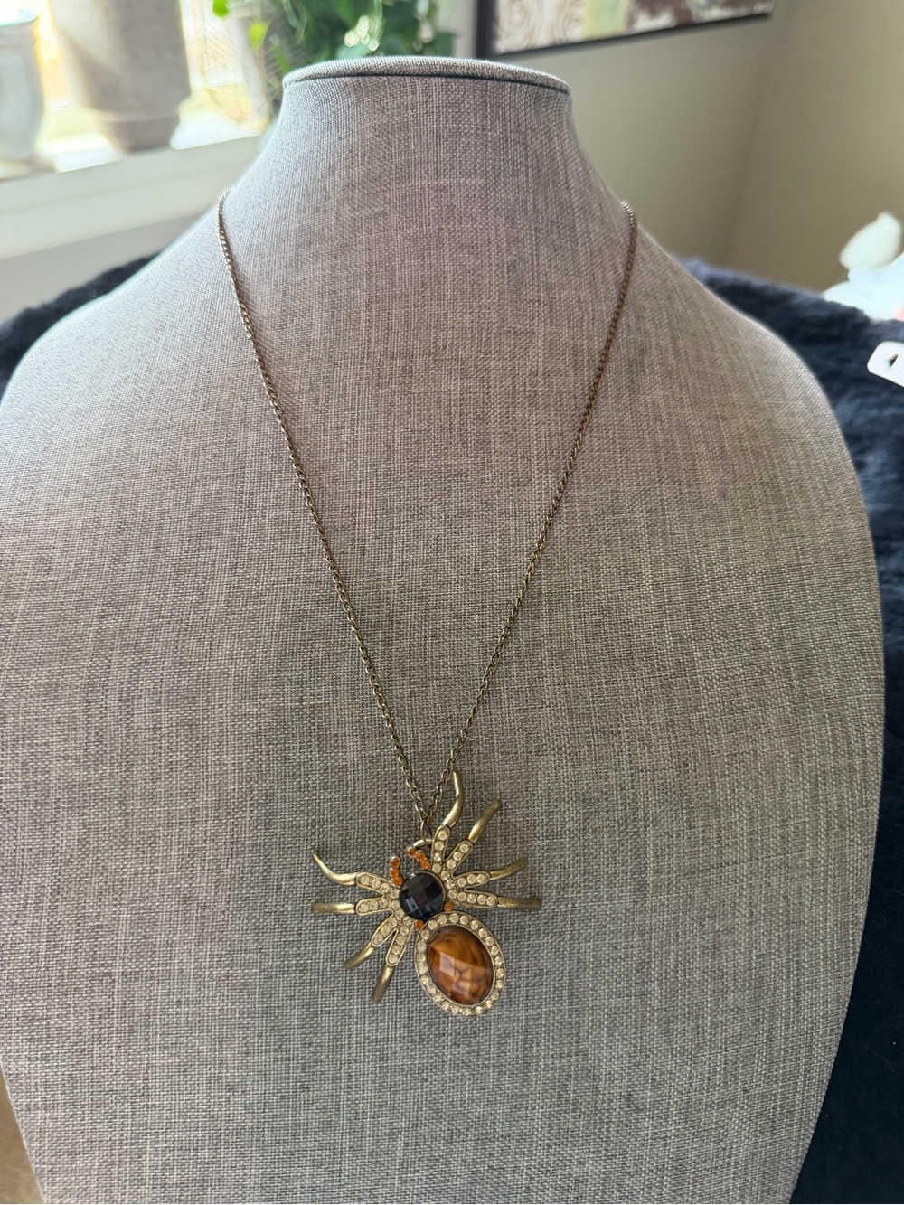 Gold-Tone Sunburst Spider Pendant Necklace with Amber and Black Stones